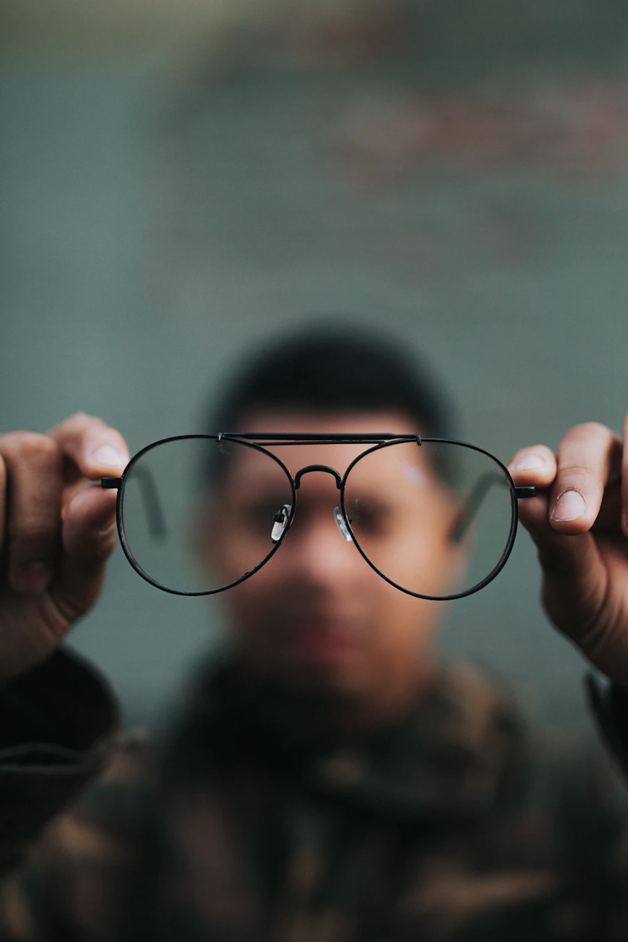Man holding his glasses